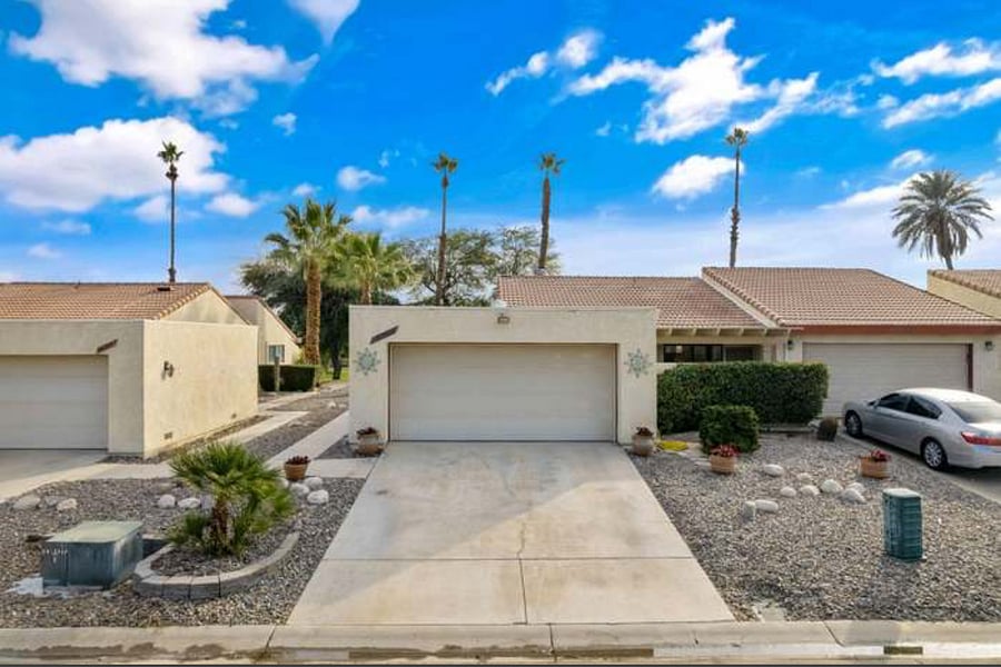 Front of property with two parking spaces on the private driveway.