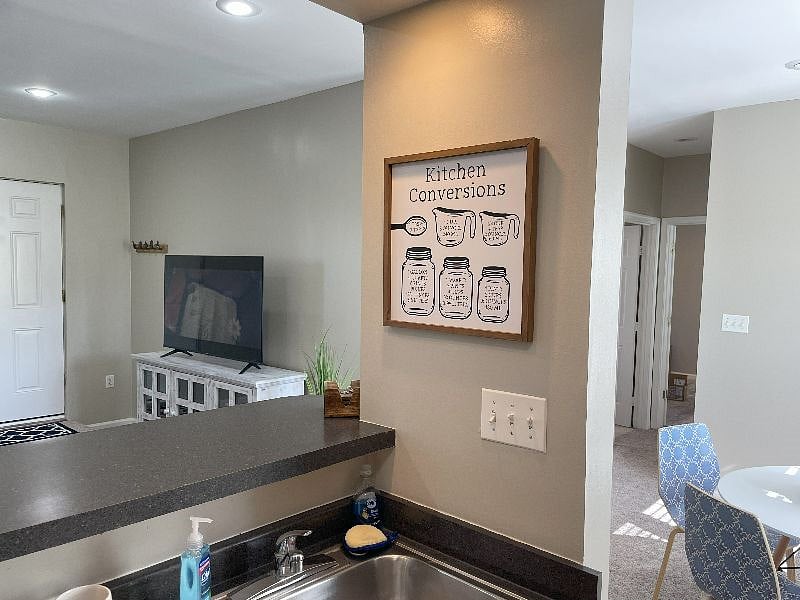 Kitchen sink view into living room