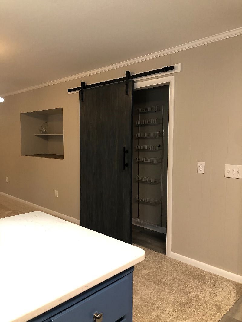 Pantry off kitchen with sliding barn door.