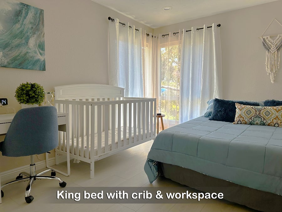 Bedroom 1 has a cozy queen bed and a crib for your little ones
