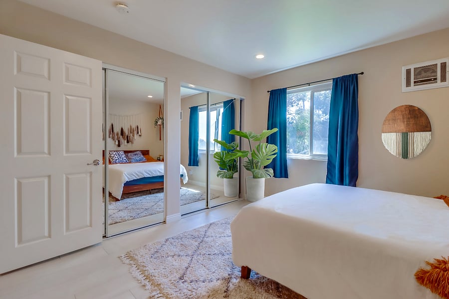 Make use of the spacious closet hidden behind the full-length mirrors in Bedroom 2