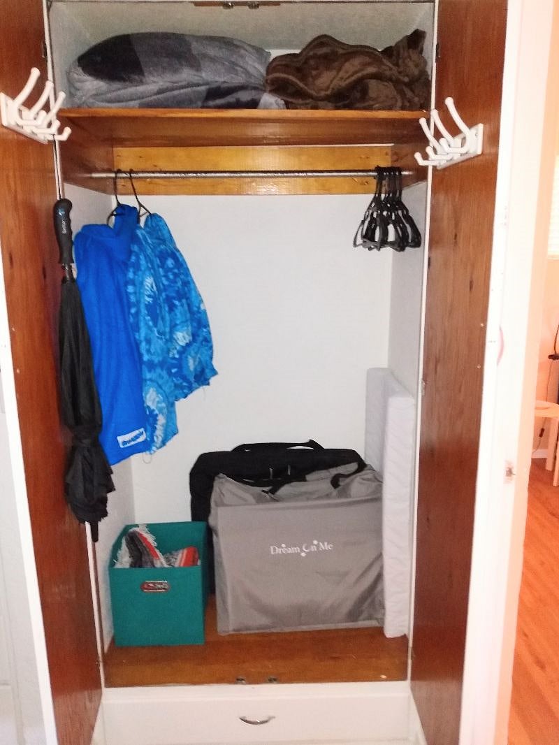 Hall closet with extra blankets, Snuggies, extra hangers, umbrella, and baby things