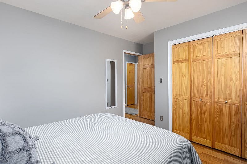 Additional view of 2nd bedroom with closet that comes with hangers, full length mirror and door to hallway.