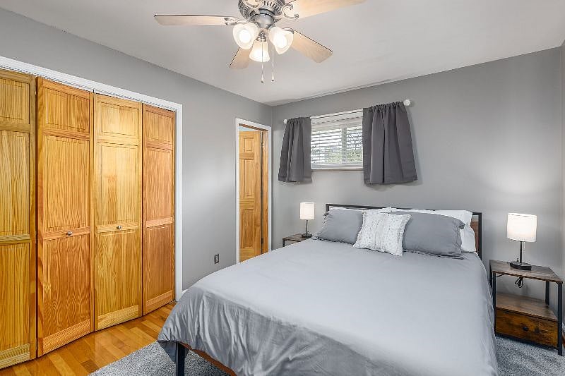 Primary bedroom with view of closet that comes with hangers and door to full bathroom. Nightstands have built in USB & outlets to make it easy to charge your devices. Full length mirror also included.
