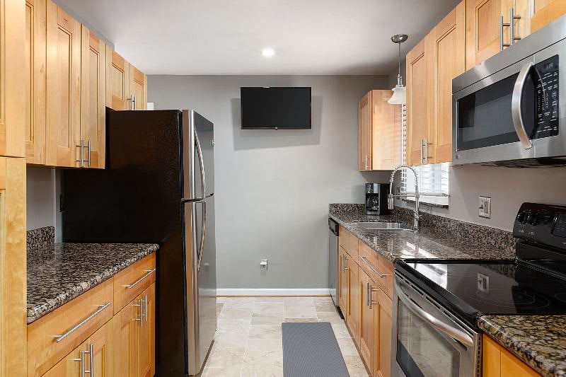 Fully-stocked kitchen that includes air fryer, toaster, coffee pot, blender, hand mixer, bakeware/cookware, storage containers, dishes, plenty of storage! Enjoy watching your favorite shows while you cook with wall mounted smart tv!