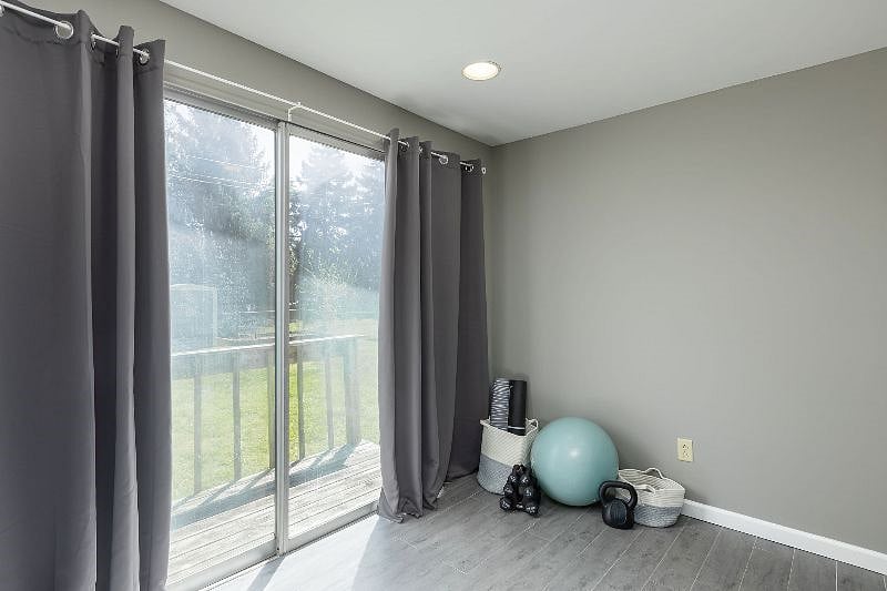 Workout space equipped with yoga mats/blocks, hand weights, exercise ball/bands and blackout curtains. Room also has full bathroom attached and separate heating/cooling unit in wall.