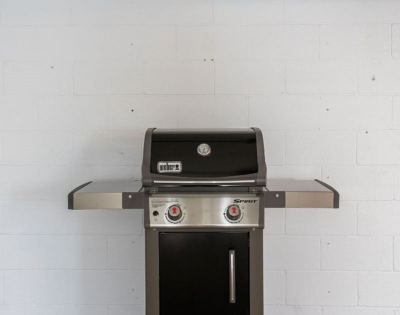 Patio also boasts a Weber grill with propane and grilling utensils included.