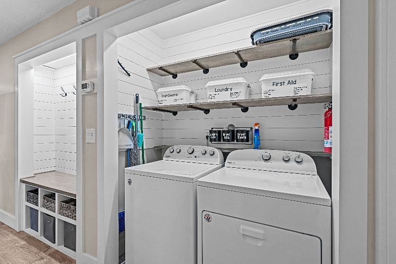 Alcove for hanging coats, bags and shoe storage. Laundry room/utility closet.