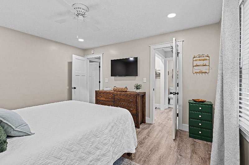 Master bedroom with 43" tv and door leading to dual closets and en suite bath