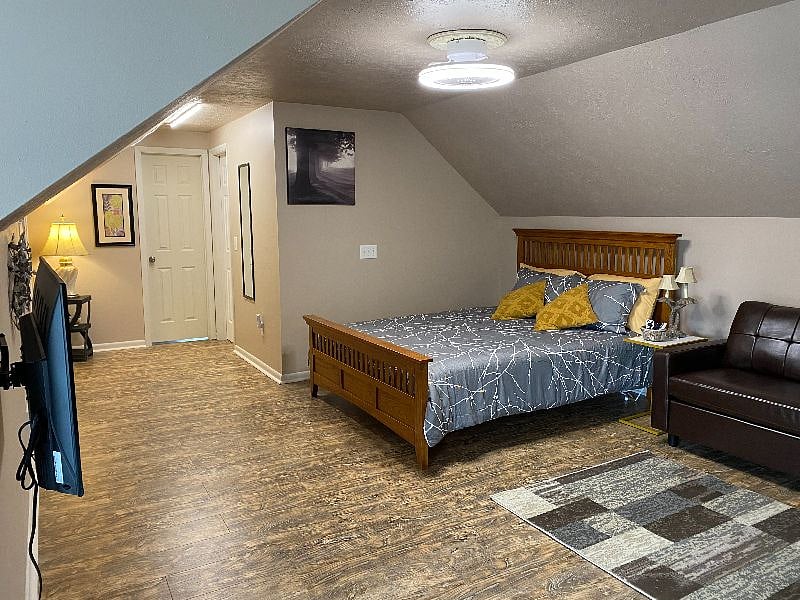 Rest on new Queen Size Mattress and bedding.  Control the lighting and TV from Bed or Sofa.