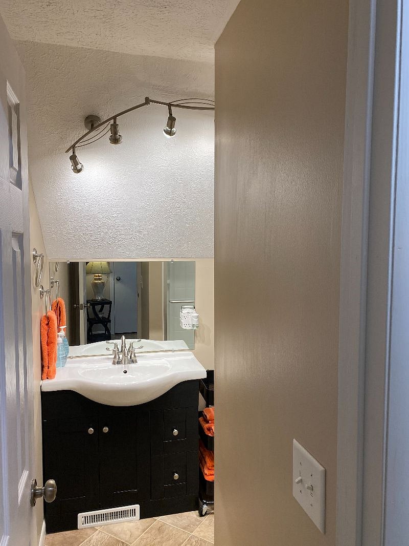 Enter the bright bathroom in Suite 1.