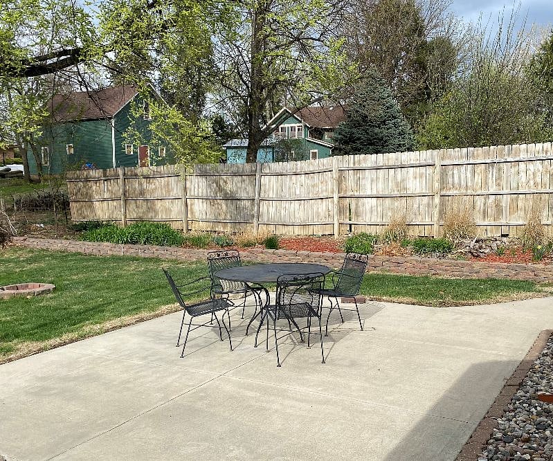 Concrete patio and patio furniture in early spring. An awning for shade is added May-September. Fire pit is available for you.