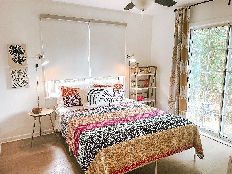 Queen bedroom includes Casper mattress, room darkening shades and drapes, sound machine, and sliding doors to backyard.