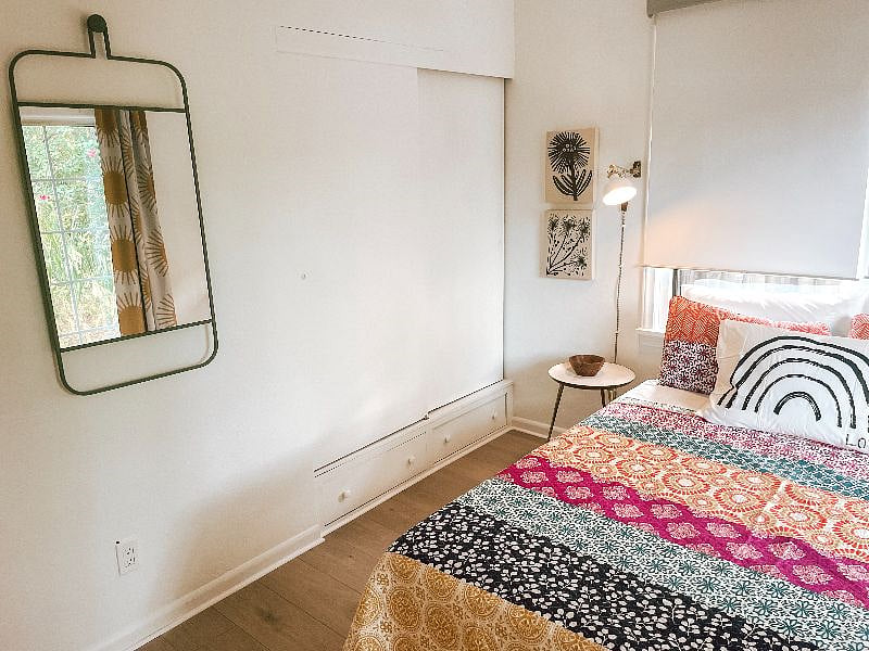 Queen bedroom includes Casper mattress, room darkening shades and drapes, sound machine, and sliding doors to backyard.