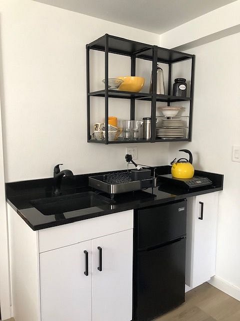 Kitchenette stocked with dishes, silverware, glasses and utensils. Hot Plate, Microwave, toaster oven and small refrigerator with freezer. Some staples provided, sugar Salt and pepper, sugar, flour, oil and limited spices.