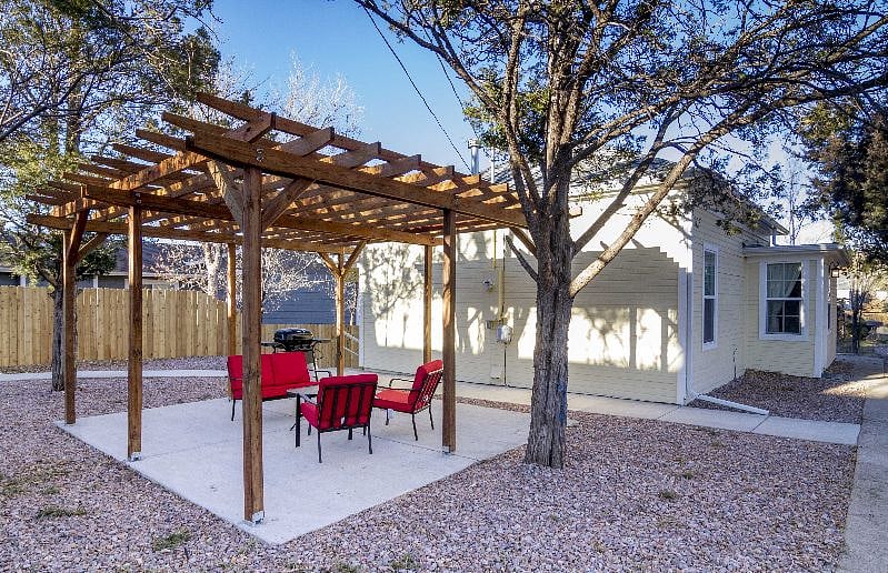 Pergola with outdoor furniture and grill