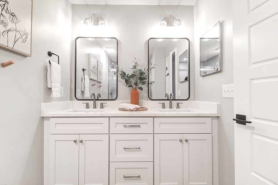 Private bathroom with dual sinks and walk-in shower