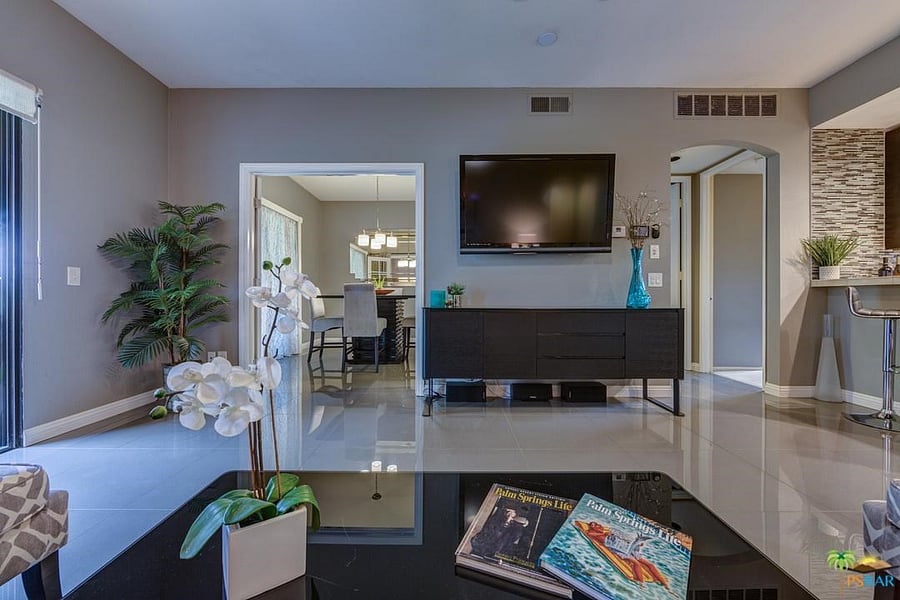 Sitting on the couch looking toward the dining area and TV
