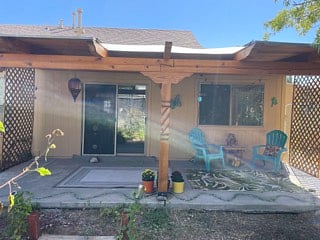 Covered back patio in private, fenced yard.