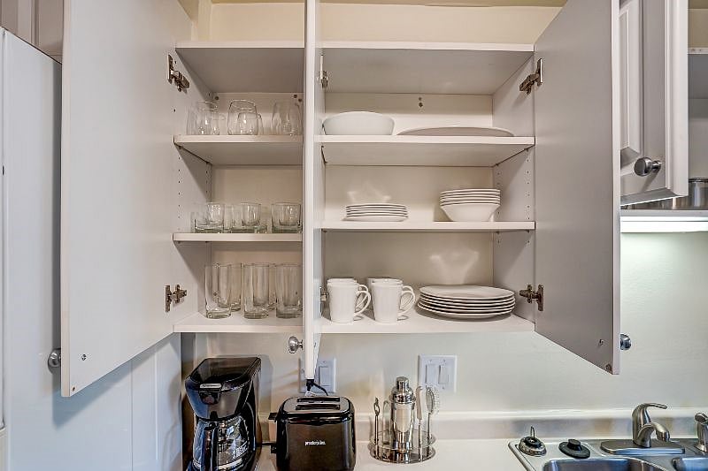 Kitchen complete with coffee maker, toaster, and tableware.