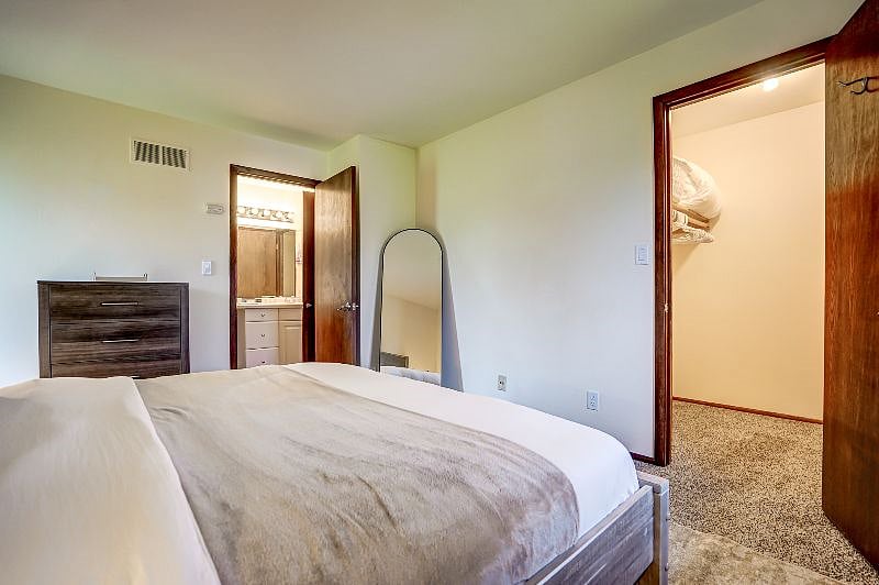 Bedroom with full length mirror and cabinet