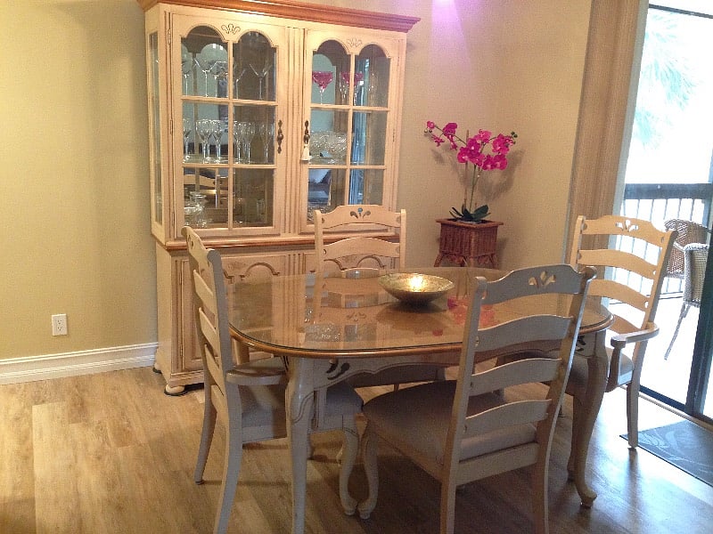 Dining room with access to front screened lanai overlooking pond.