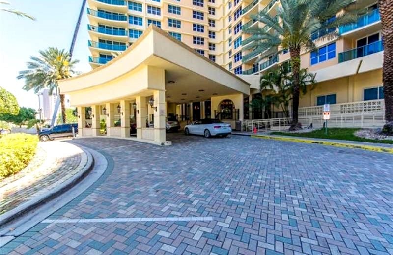 Covered building entrance used for Secure Complementary Valet Service to Park your Car in the Garage. Ramp on the side for Wheelchairs. No Need for you to look for your car in dark parking places or to park under the rain