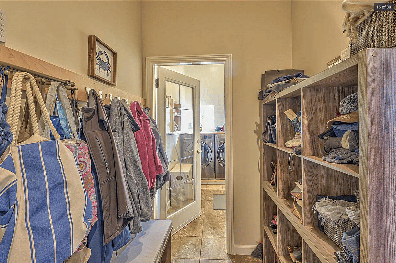 Mud room accessed by door from garage with view/door to laundry room.