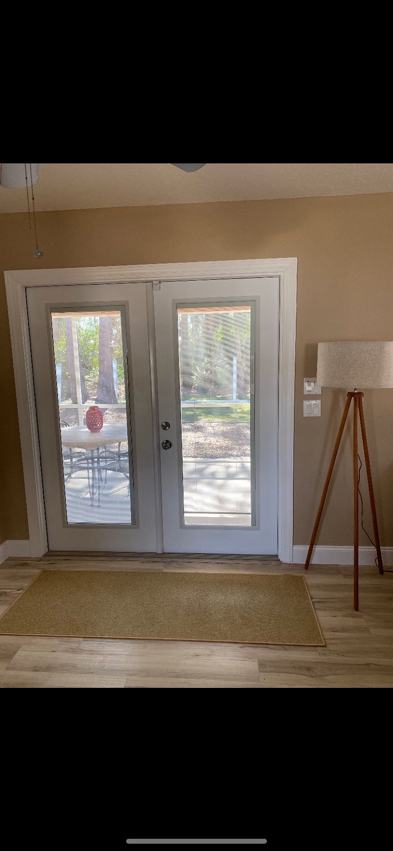 French Doors with built in hurricane  shutters, leading outside to the lanai/screened in porch 
