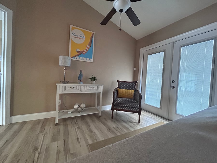 French Doors to shaded Lanai with table and chairs