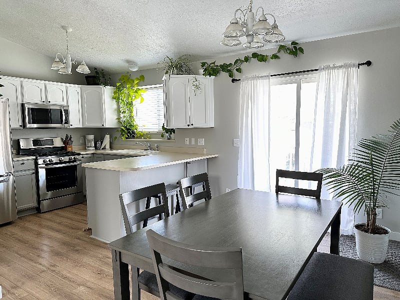 Dining area adjacent to kitchen leads out to backyard balcony.