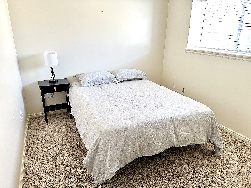 downstairs bedroom - queen size bed, nightstand, and closet