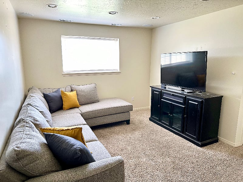 downstairs family room with Roku TV and full sectional
