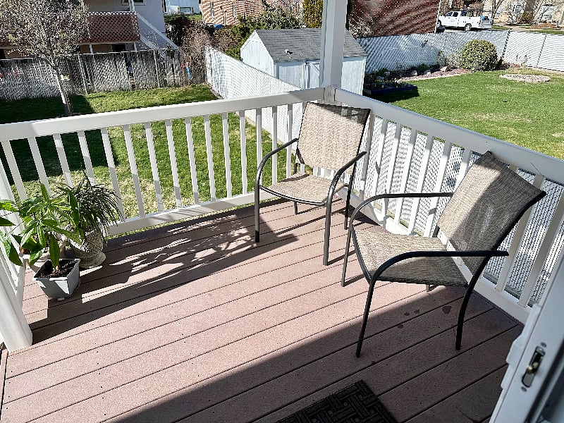 balcony off kitchen with outdoor seating. fully fenced yard