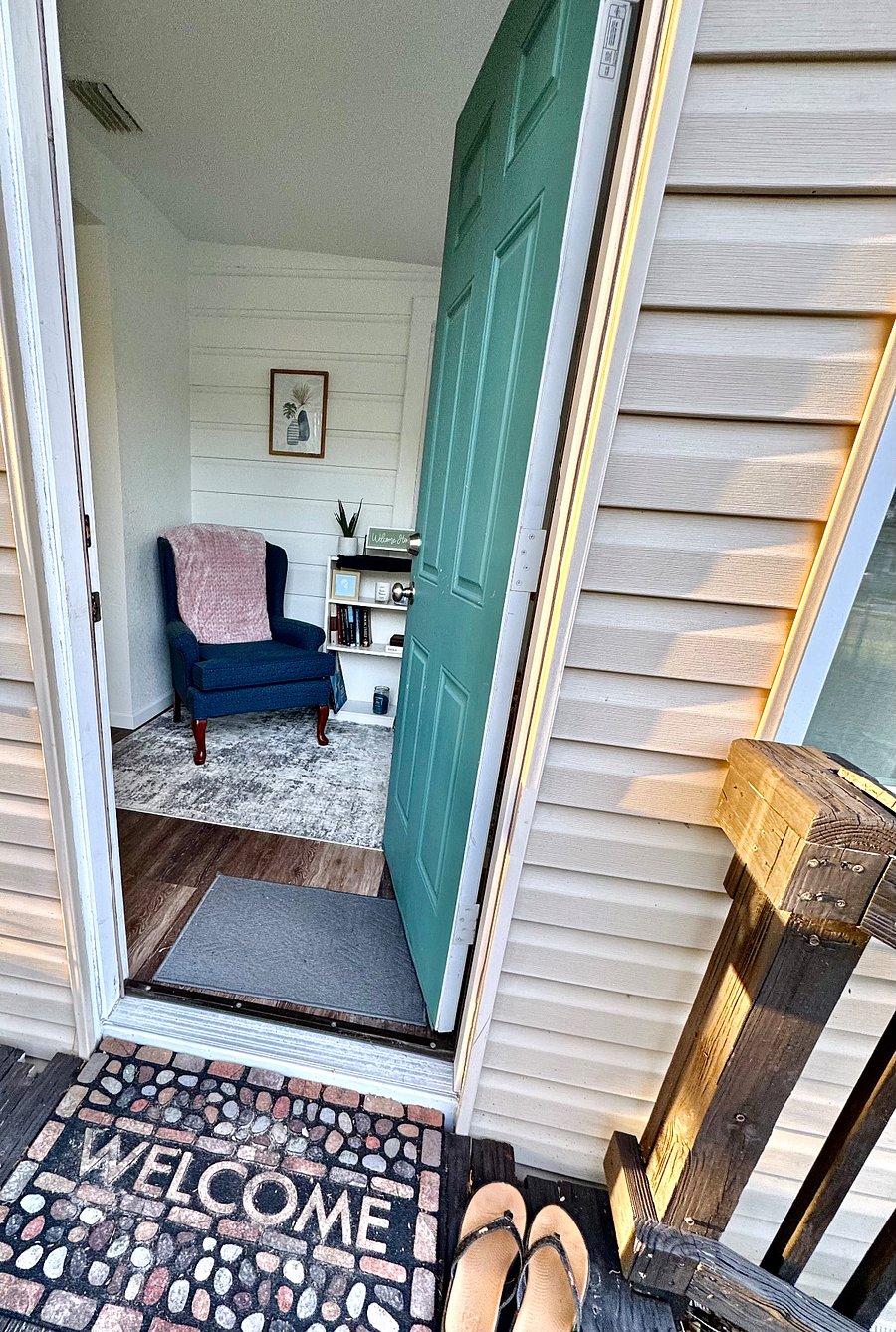Enter the home to an enclosed sunroom with extra desk and reading nook.