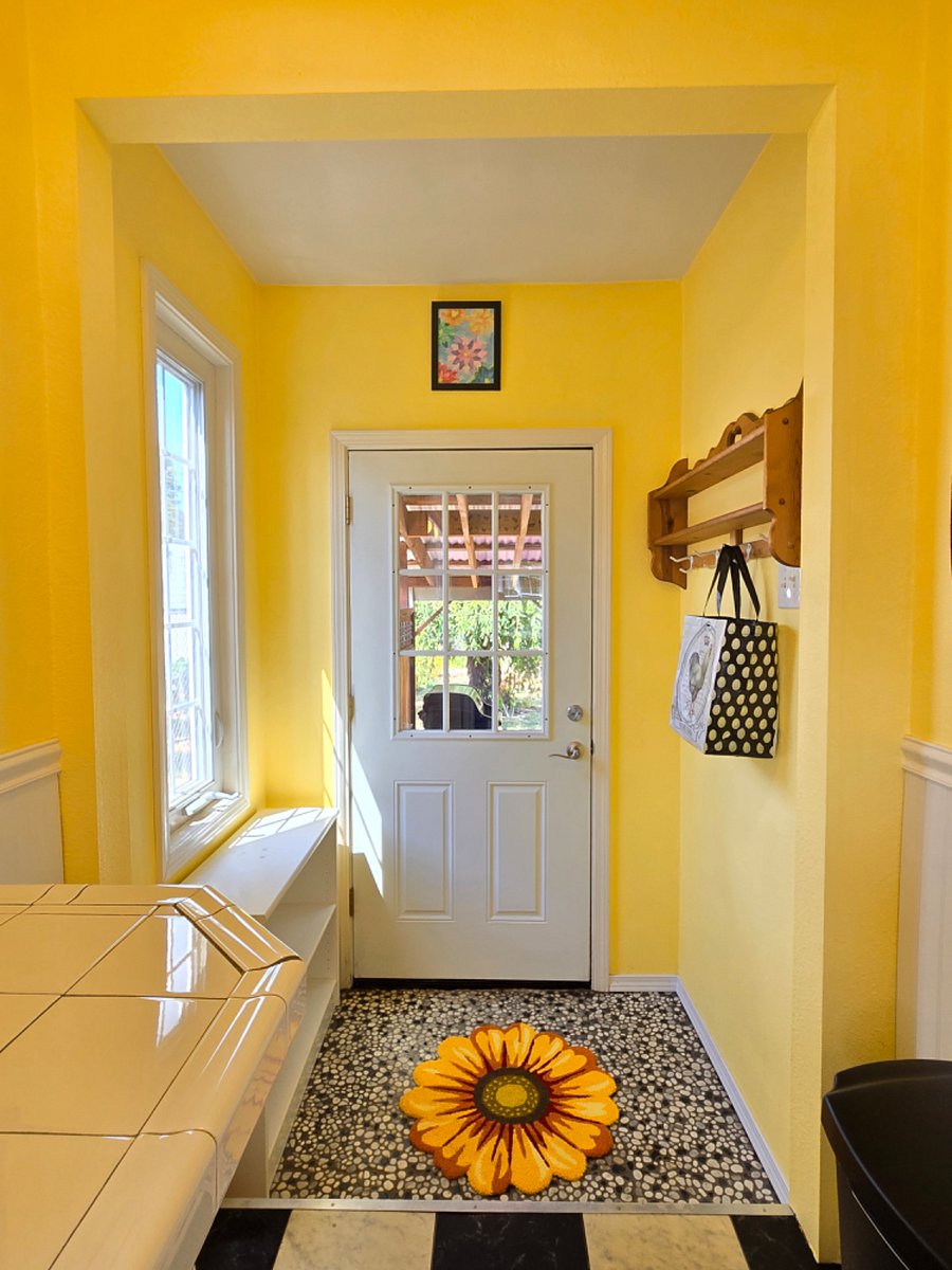 Kitchen door to patio with BBQ grill.