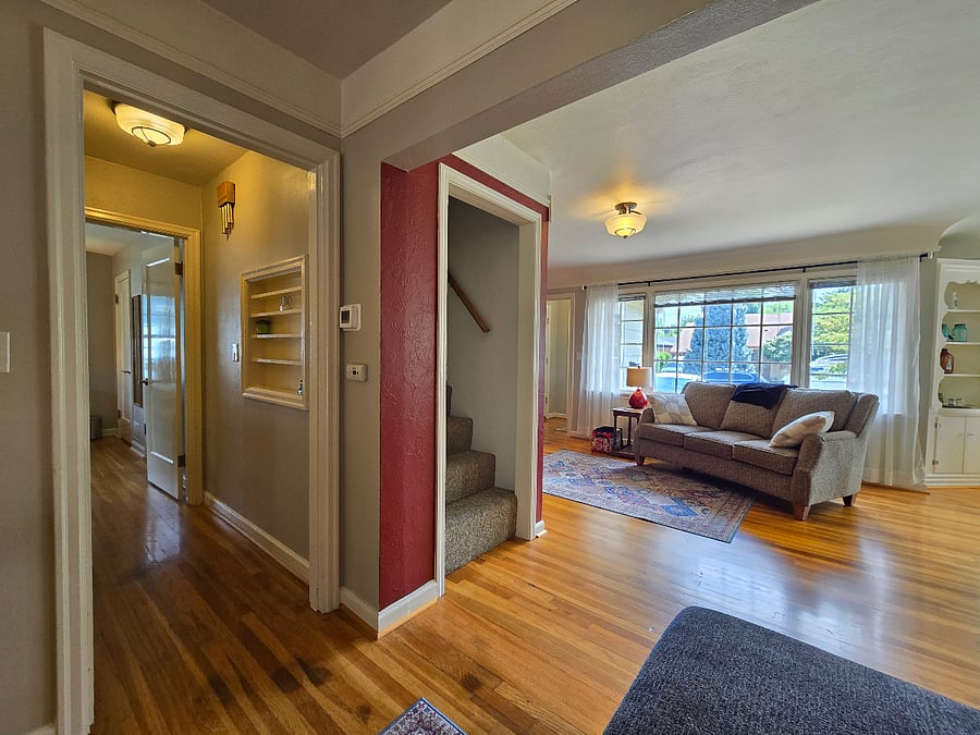 Hall leads to the bathroom and downstairs bedroom, and the stairs go to the upstairs bedroom.