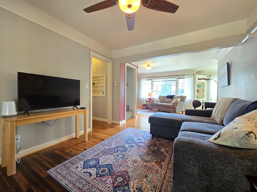 Two separate sitting areas, one with TV, one without.