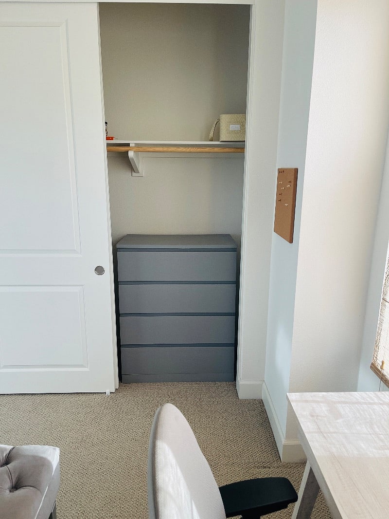 Closet with a dresser.