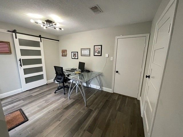 Office area and laundry room (behind barn door) off kitchen. Garage door is plain white door. Half bath is the door on the right.