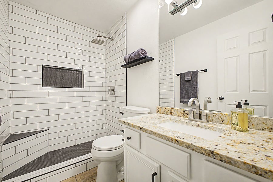 Bedroom 1's en suite bathroom with remodeled (2026) walk-in shower.