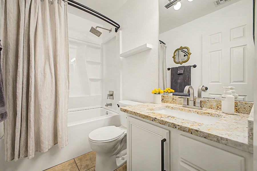 Bedroom 2's en suite bathroom with a shower/tub, remodeled in 2026