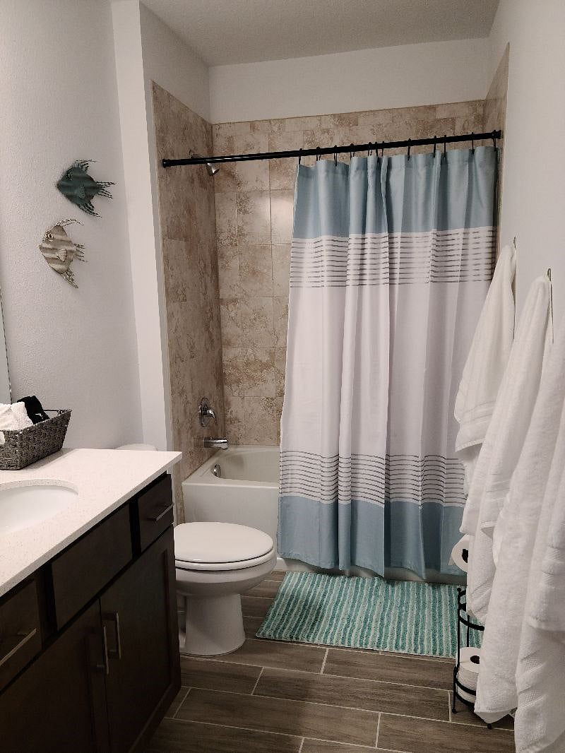 Main bathroom with tub and shower.