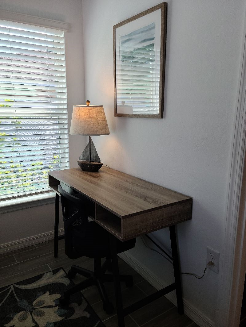 Desk in primary bedroom for working remotely.