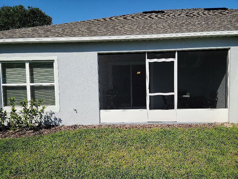Screened-in lanai opens to privately fenced back yard.