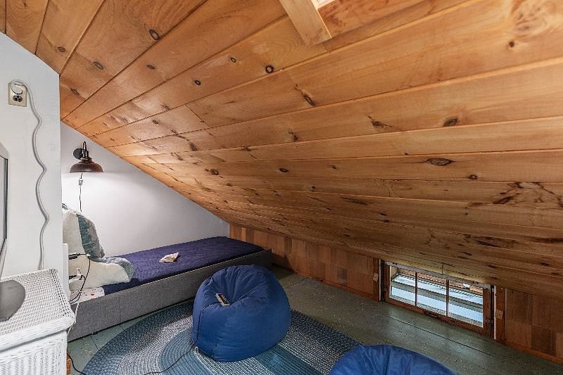 Upstairs - First bedroom Twin bed (under eave), shares space with the other two twin beds. To get to the second bedroom upstairs (queen) you have to walk through this room. There is a door at the top of the stairs and a door between bedrooms.