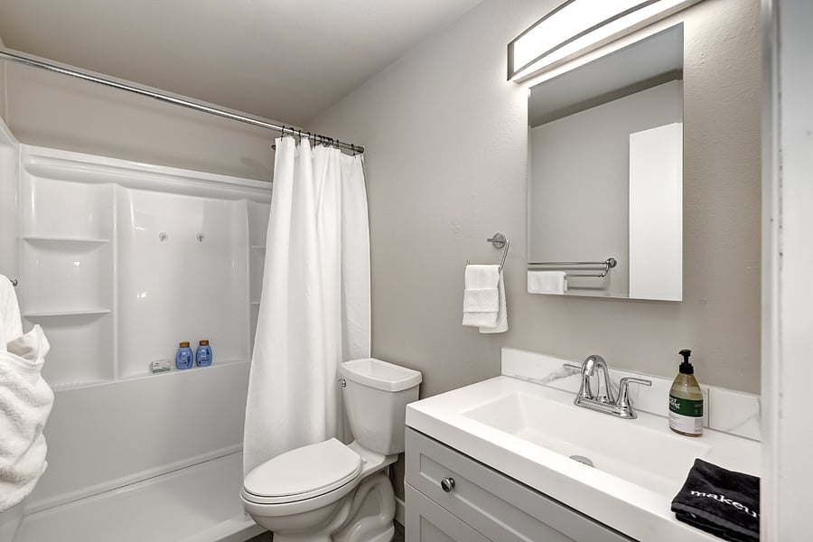 Bathroom located in the hall with access from both bedrooms and the living area