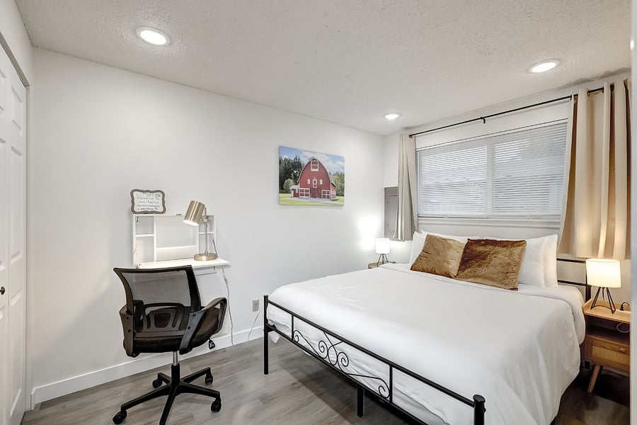 Queen bed and desk in second bedroom
