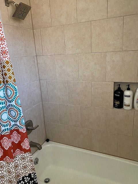 Full-size bathroom with full tub and shower