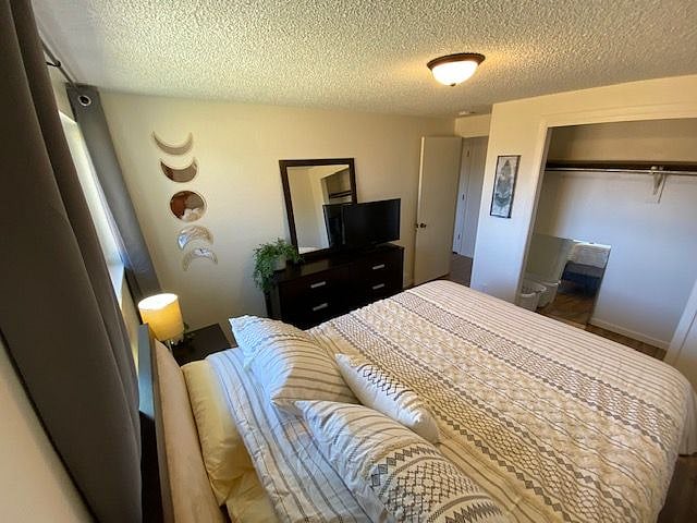 2nd bedroom with queen bed and TV